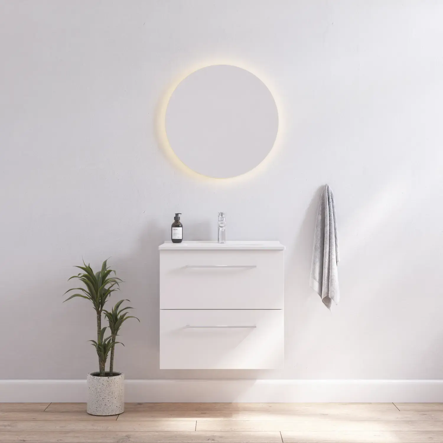 Inspiration für ein Badezimmer mit einem schmalen weißen Waschtischunterschrank mit weißen Griffen und einem eleganten Waschbecken mit einem schönen runden Spiegel mit hellen, weißen Wänden und Holzboden für einen hellen und minimalistischen Look.